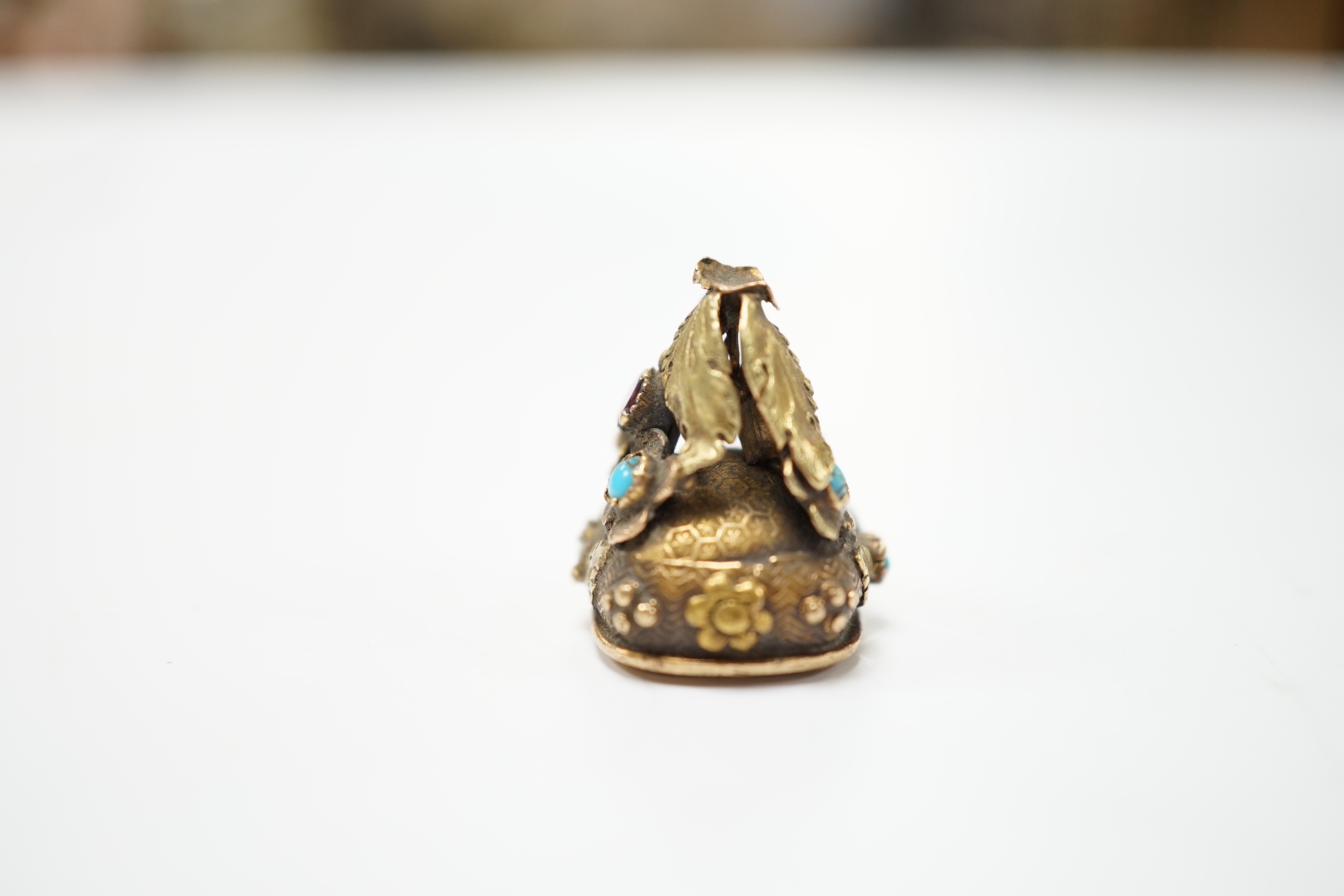 A 19th century yellow metal, garnet and turquoise mounted foil backed amethyst fob seal, the matrix inscribed Lamitie?, 17mm (a.f.).